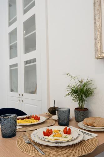 a table with plates of food on top of it at Petit Biniaraix in Sóller