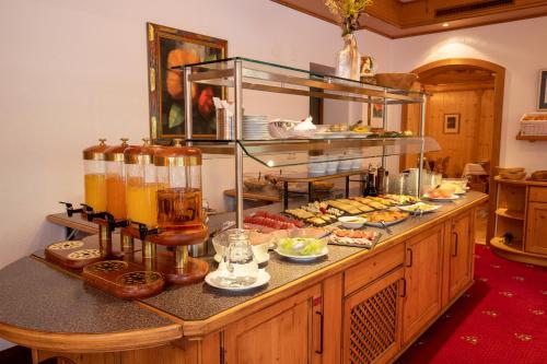 a buffet line with food and drinks on it at Hotel Persura in Ischgl