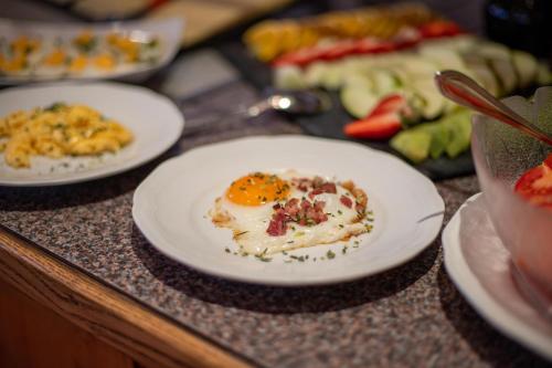 a table topped with plates of food on a counter at Hotel Persura in Ischgl