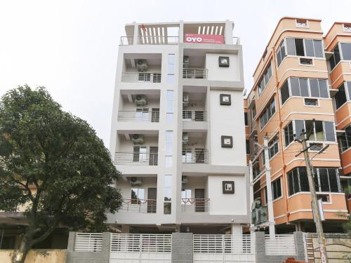 a white building with balconies on the side of it at Hotel O Prashant Villa in Rānchī
