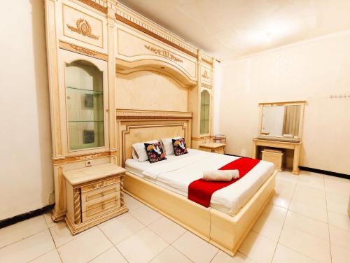 a bedroom with a large bed in a room at YUTAKA INN Sriwijaya Tegalsari Surabaya in Surabaya