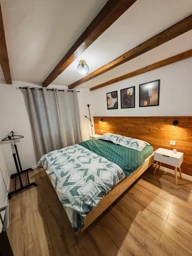 a bedroom with a large bed and a table at Cabana Tudor in Aiud