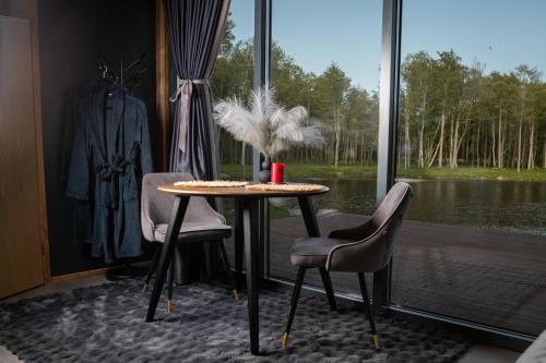 a table and two chairs in front of a window at Torgu Kuningriigi palee in Rahuste