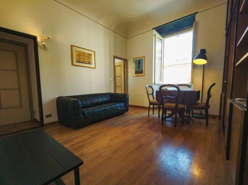 a living room with a couch and a table and chairs at Casa Matteotti By Vacanze in Chiavari in Chiavari