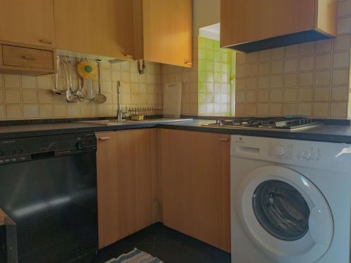a kitchen with a washing machine and a sink at Casa Matteotti By Vacanze in Chiavari in Chiavari