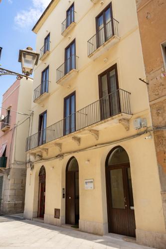 a building with a balcony on top of it at Aria di Mare Apartments in Trapani