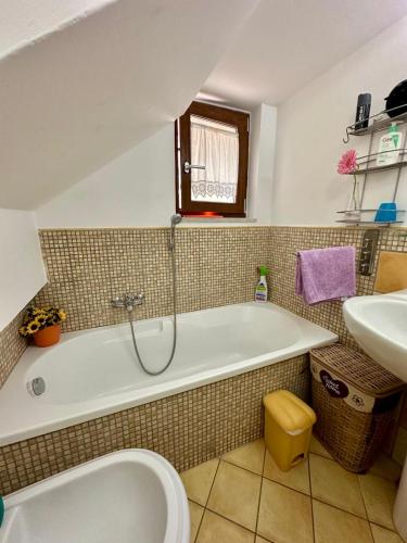 a bathroom with a tub and a sink at Al Papavero Rosso in Castellammare di Stabia