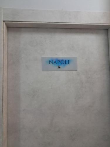 a sign on a wall with the word navaho at 40 Parallelo in Castel Volturno