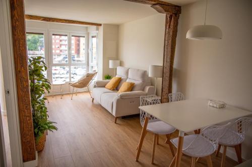 a living room with a couch and a table at TxOKO ETXEA in Bermeo