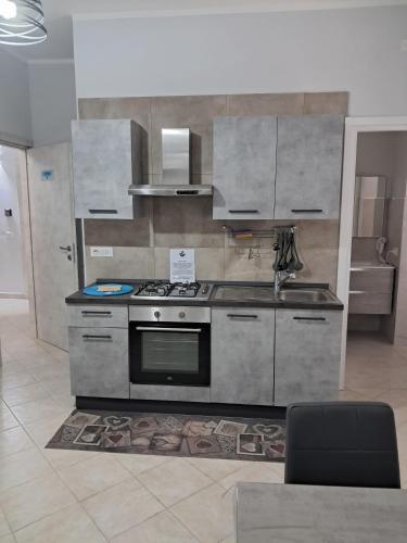 a kitchen with a stove and a sink at 40 Parallelo in Castel Volturno