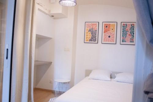 a bedroom with a bed and three pictures on the wall at Charme rare sous les voûtes in Royat