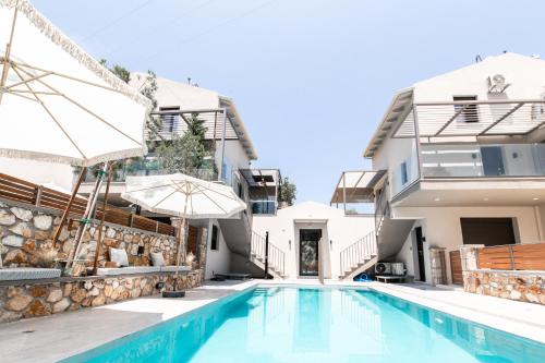a villa with a swimming pool and a house at September15 Suites- Meganisi in Meganisi