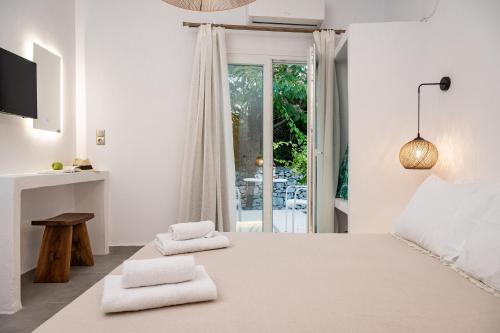a bedroom with a large bed with towels on it at Tegame Apartments in Pythagoreio