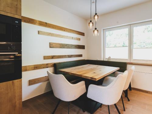 a dining room with a wooden table and chairs at NEW! Chalet Carina by we rent in Zell am See