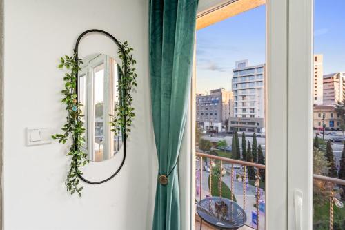 a window with a green curtain and a mirror at Heart Of Nicosia - The Gem in Nicosia