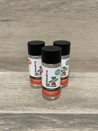 three containers of paint sitting on a table at The Obsidian Suite , next to Heraklion Airport in Heraklion