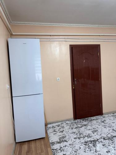an empty room with a refrigerator and a door at Дом для отдыха in Pokrovka