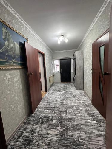 an empty hallway with a long carpeted corridor at Дом для отдыха in Pokrovka