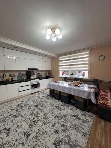 a large kitchen with a table in the middle at Дом для отдыха in Pokrovka