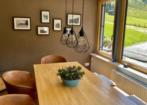 a dining room table with chairs and a potted plant at Pauls Huesle in Gargellen