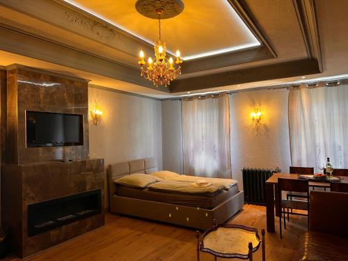 a bedroom with a bed and a television and a table at CG Haensch in Großschönau