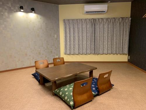 a dining room with a wooden table and chairs at HOTEL PRELE Asakusa ホテルプレール浅草 in Tokyo