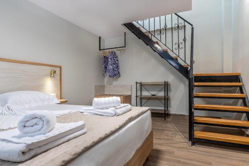 a bedroom with a bed with towels on it at Seatherial Apartments Paleochora in Palaiochóra