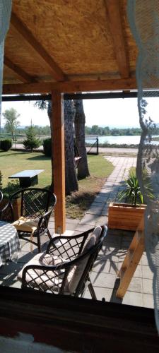 a patio with chairs and a table and a table and a table and chairs at Vikendica Markovic in Tešanovića Mala