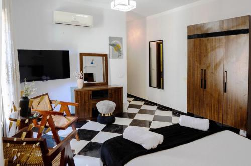 a living room with a checkered floor at Chic 2BR Apt 8min to Airport Family& work ready in Cairo