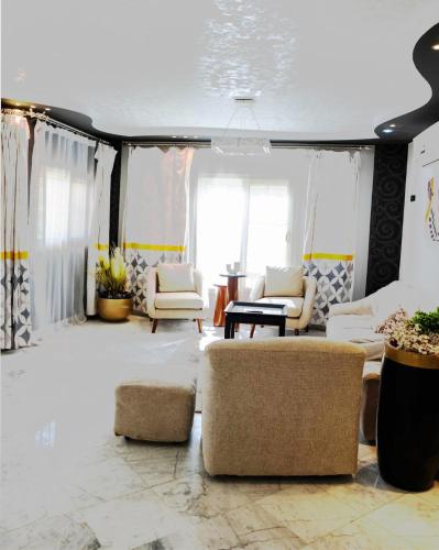 a living room with couches and chairs at Chic 2BR Apt 8min to Airport Family& work ready in Cairo