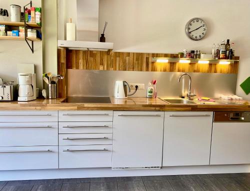 a kitchen with white cabinets and a sink at Pauls Huesle in Gargellen