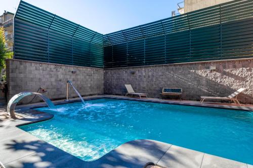 a swimming pool with a water slide in a building at Alhambra "Etna Charme" - Guest House in Giarre