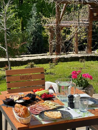 a wooden table with food on top of it at Cetatuia in Măgura
