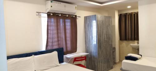 a small room with a bed and a window at Sahasra Sree Suites Inn in Hyderabad