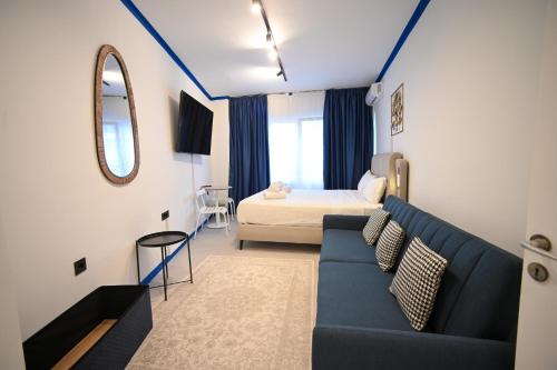 a living room with a couch and a bed at Syntagma Plaka Suite by Zeussuites in Athens