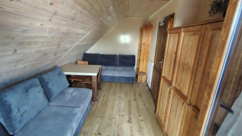 a living room with a couch and a table at Gama Spa in Władysławowo
