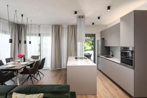 a kitchen and dining room with a dining table at Vila Aurora in Vrsar