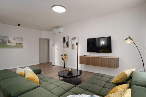a living room with a couch and a flat screen tv at Vila Aurora in Vrsar