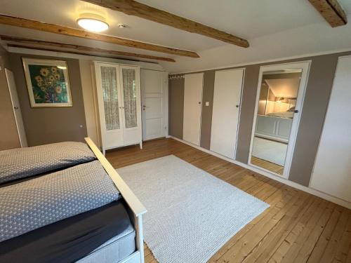 a bedroom with a bed and a mirror at Cozy 2 bedroom house on a farm just outside Lillestrøm in Lillestrøm