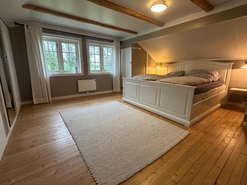 a bedroom with a bed and a white rug at Cozy 2 bedroom house on a farm just outside Lillestrøm in Lillestrøm