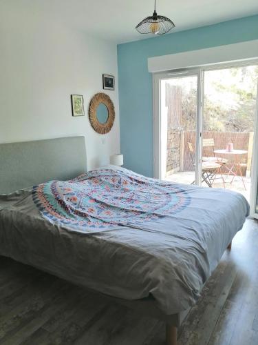 a bedroom with a bed with a blanket on it at Maison dans les Corbières in Montséret