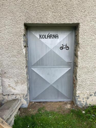 a garage door with a bike sign on it at Penzion Na Bobrovníku in Lipova Lazne
