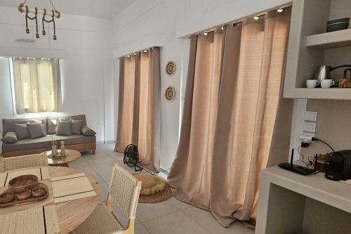 a living room with a table and a couch at Aenya Kythnos Villas in Kithnos