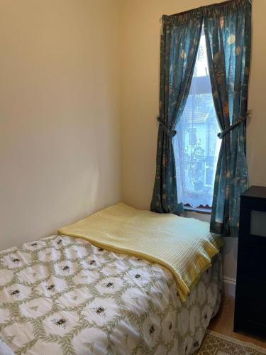 a small bedroom with a bed and a window at Ilford Express Room in East London in Ilford