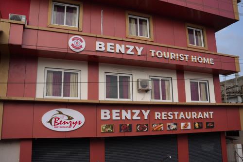 a building with signs on the side of it at Benzy Tourist Home in Ponnāni