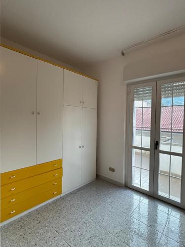 an empty room with white cabinets and a window at Villa Madonnina in riva al fiume Tirino in Bussi sul Tirino