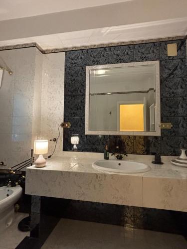 a bathroom with a sink and a mirror at Villa Madonnina in riva al fiume Tirino in Bussi sul Tirino
