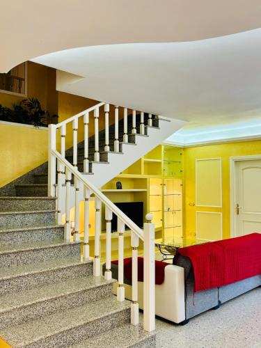 a living room with a staircase and a couch at Villa Madonnina in riva al fiume Tirino in Bussi sul Tirino