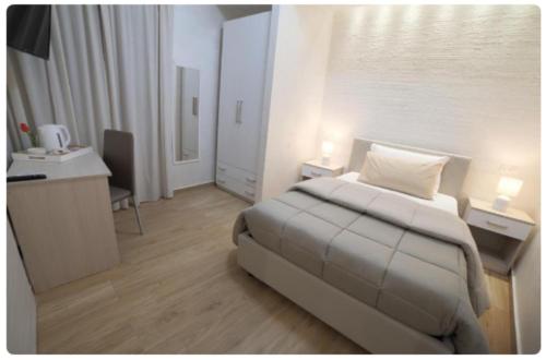 a hotel room with a bed and a desk and a desk at GREEN - Bed and Breakfast a Castrovillari in Castrovillari