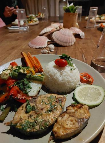a plate of food with rice and vegetables on a table at Moroccan Boho Surf House in Agadir